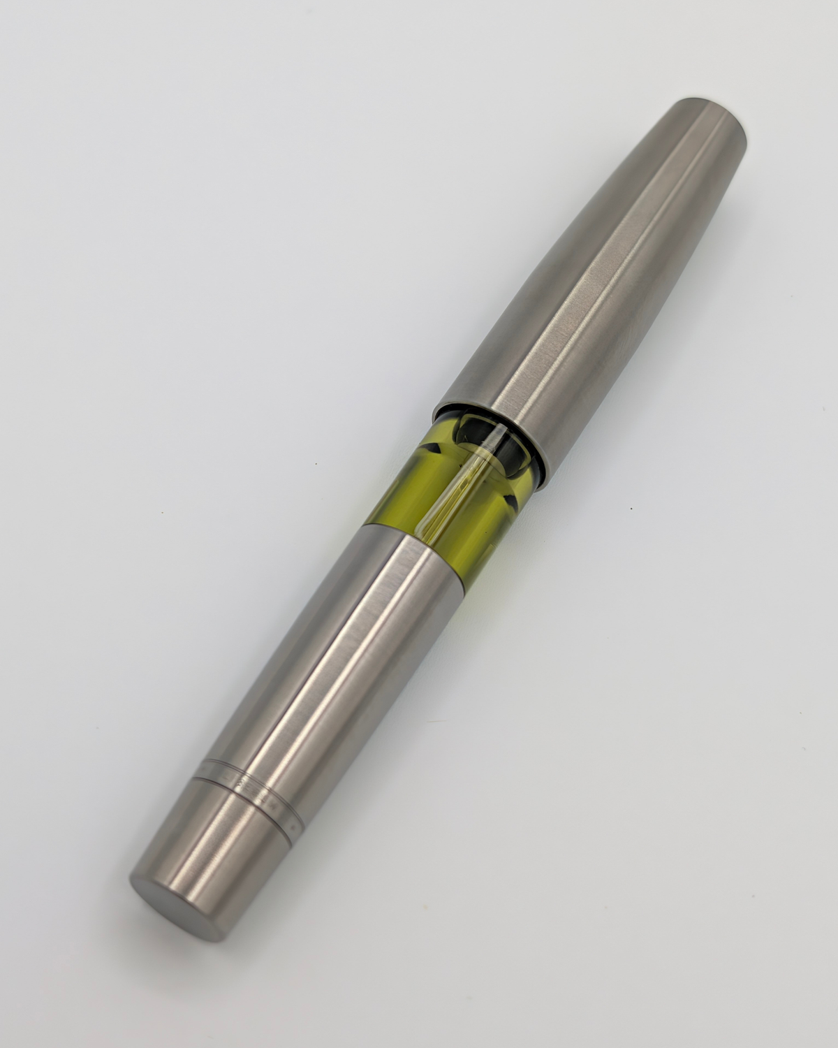 Liberum Volucris Vac Titanium pocket fountain pen, capped, in brushed titanium with a transparent ink window