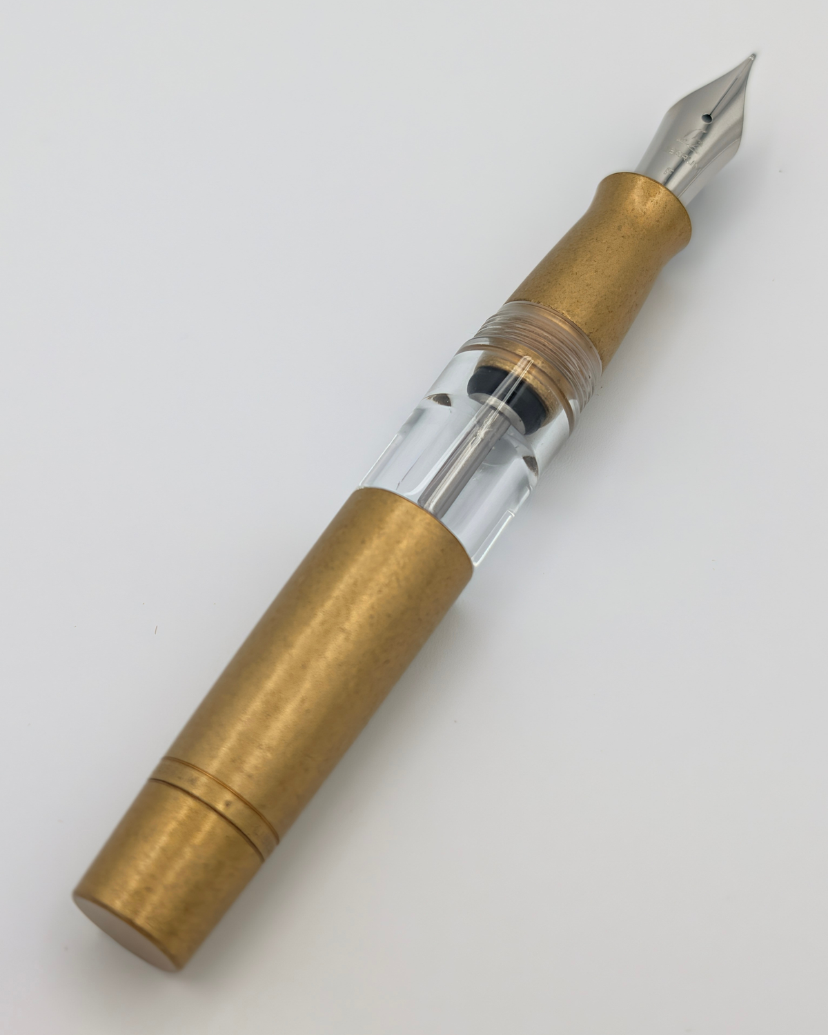 Liberum Volucris Brass Stone Washed fountain pen uncapped with a #6 stainless steel nib