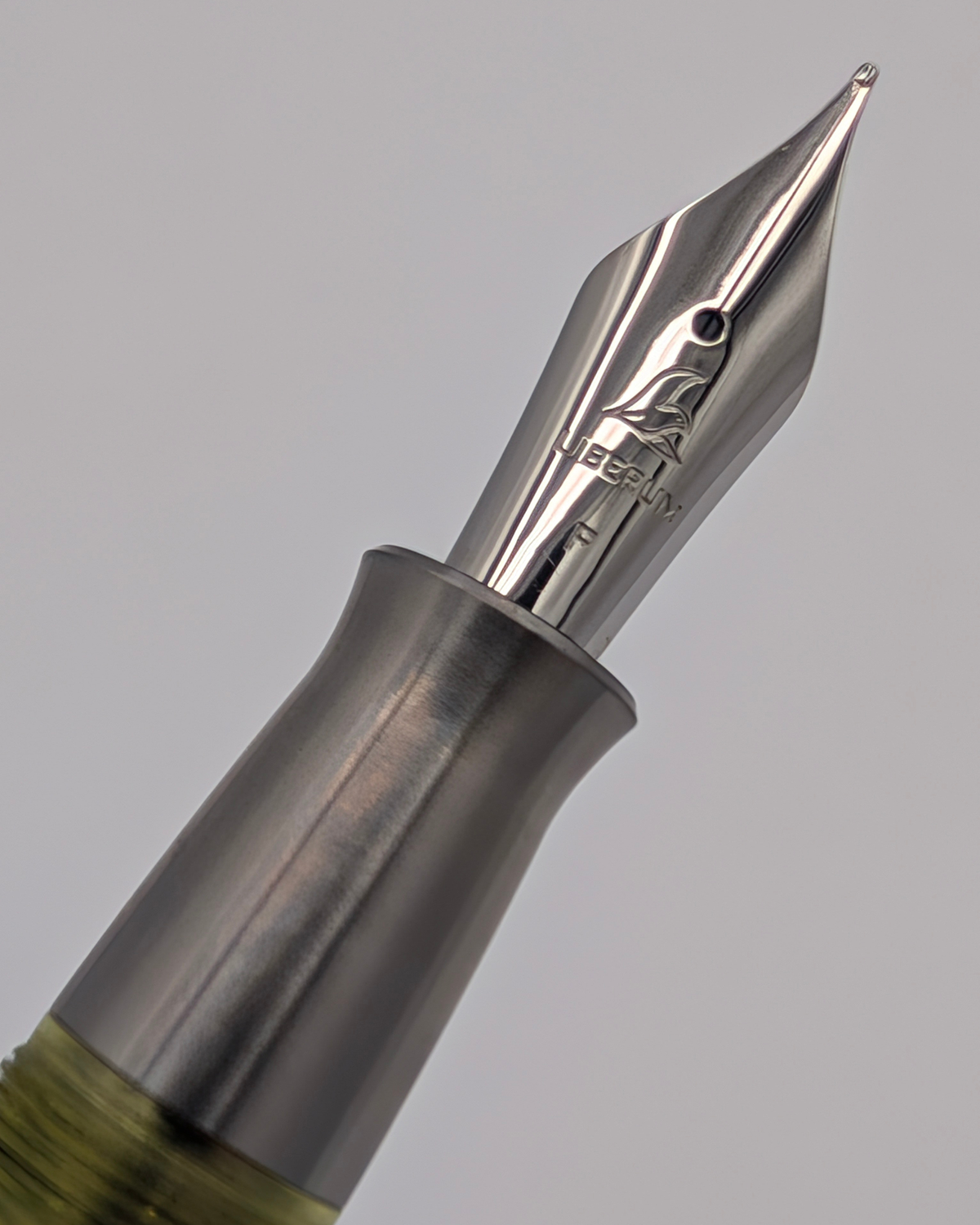 Liberum-engraved #6 stainless steel nib on the Volucris Vac Titanium fountain pen