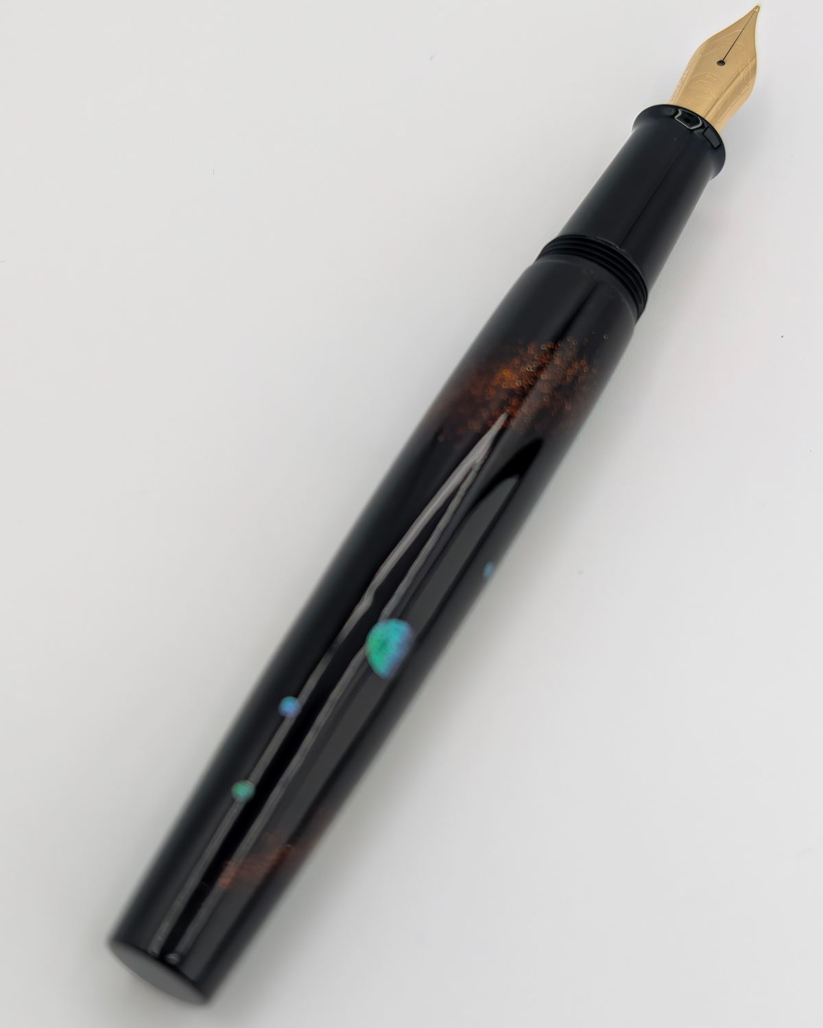 Liberum Star Shine fountain pen uncapped with a gold-tone engraved nib